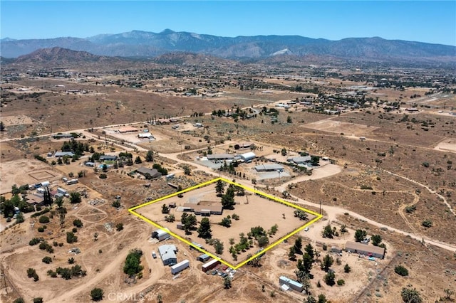 birds eye view of property featuring a mountain view and view of desert