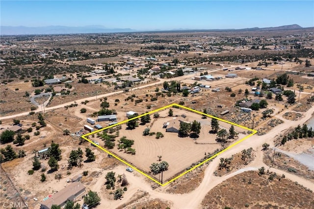 birds eye view of property with a mountain view