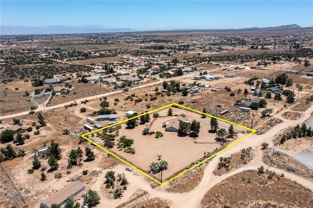 birds eye view of property featuring view of desert and a mountain view