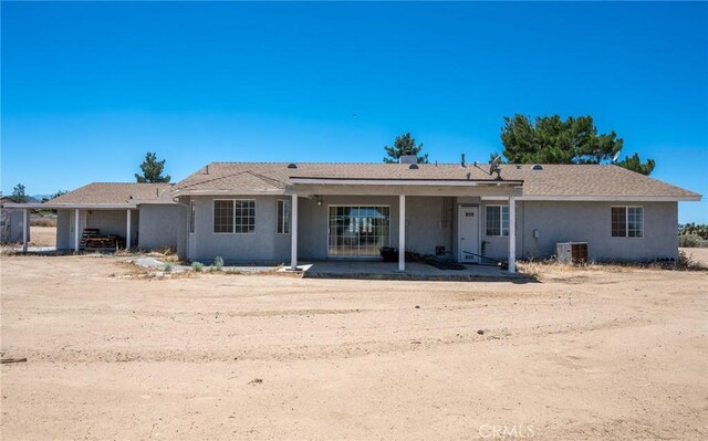 view of front of home with central AC unit and a patio area