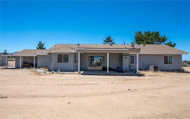 back of house featuring cooling unit, a patio area, and stucco siding