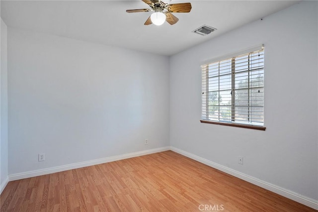 empty room with ceiling fan and light wood-type flooring