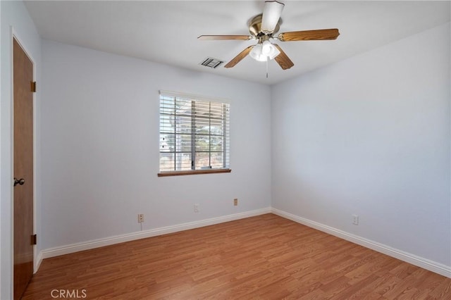 spare room with light hardwood / wood-style floors and ceiling fan