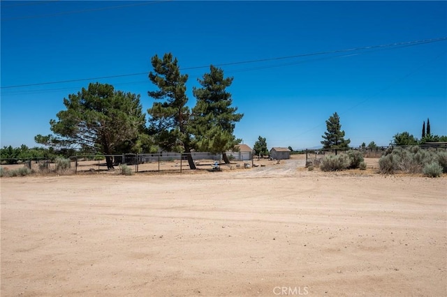 view of yard featuring fence and a rural view