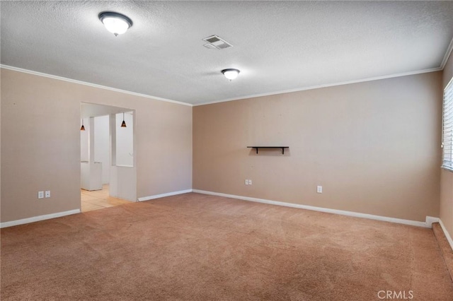 empty room featuring light carpet, baseboards, visible vents, ornamental molding, and a textured ceiling