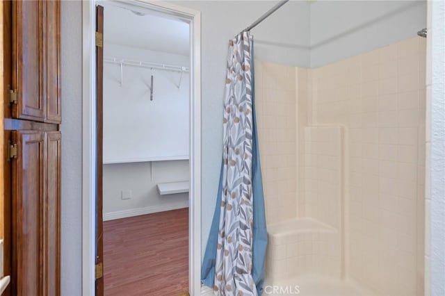 bathroom featuring hardwood / wood-style floors and curtained shower