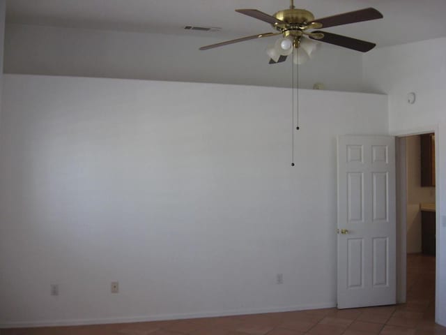 unfurnished room with light tile patterned floors and ceiling fan