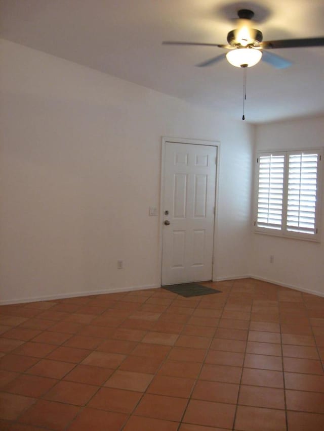 tiled empty room with ceiling fan