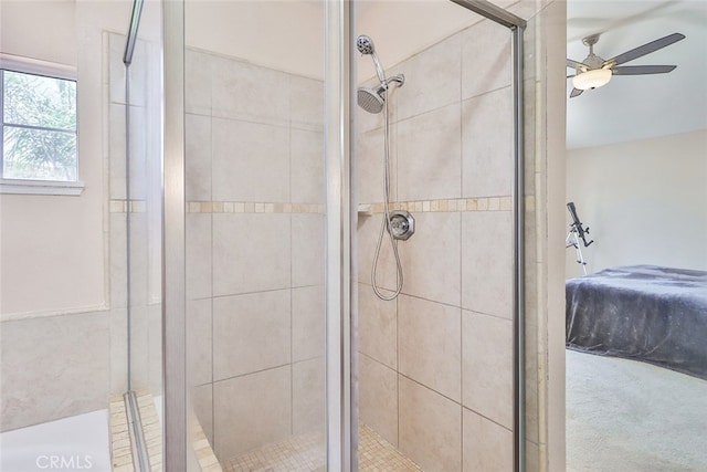 bathroom featuring ceiling fan and an enclosed shower