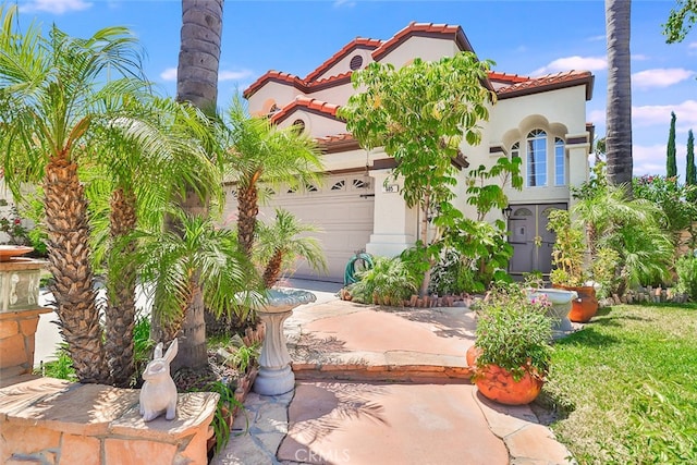 mediterranean / spanish house featuring a garage