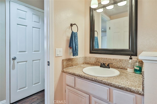 bathroom featuring hardwood / wood-style flooring and vanity