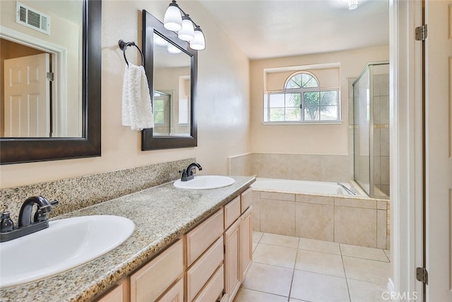 bathroom with dual vanity, tile patterned flooring, and separate shower and tub