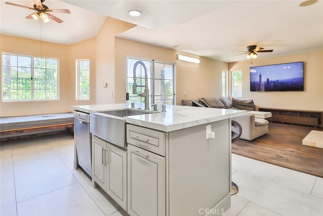 kitchen featuring dishwasher, a kitchen island with sink, a wealth of natural light, and ceiling fan