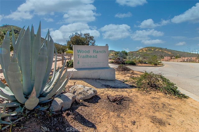 community sign with a mountain view