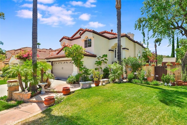 mediterranean / spanish-style home with a garage and a front lawn