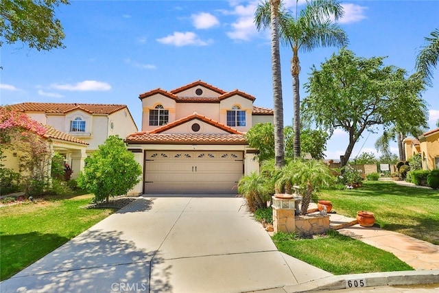 mediterranean / spanish-style house featuring a garage and a front yard