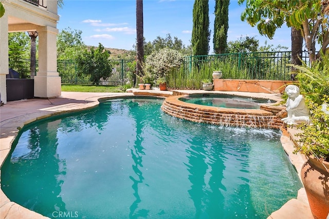 view of swimming pool featuring an in ground hot tub and pool water feature