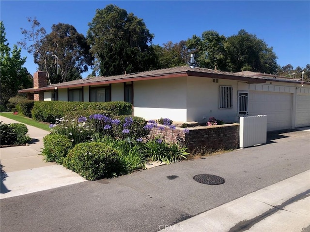 view of side of home featuring a garage