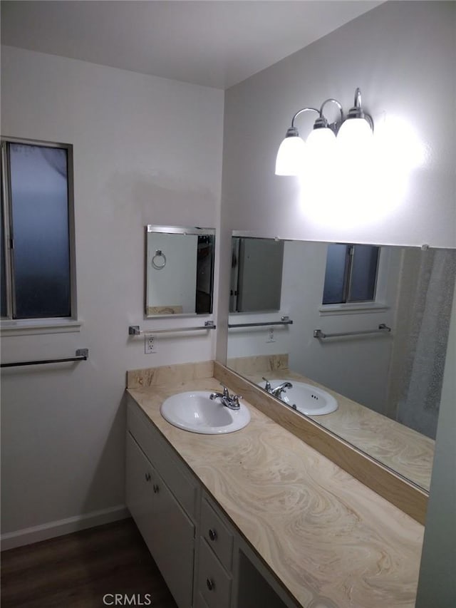 bathroom featuring hardwood / wood-style flooring and vanity