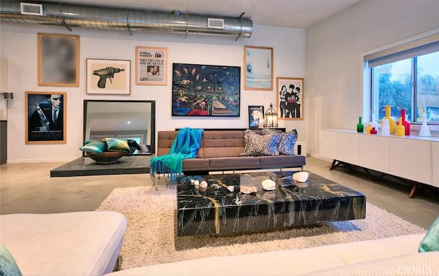 living room featuring concrete flooring