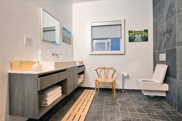 bathroom featuring tile walls, vanity, and toilet