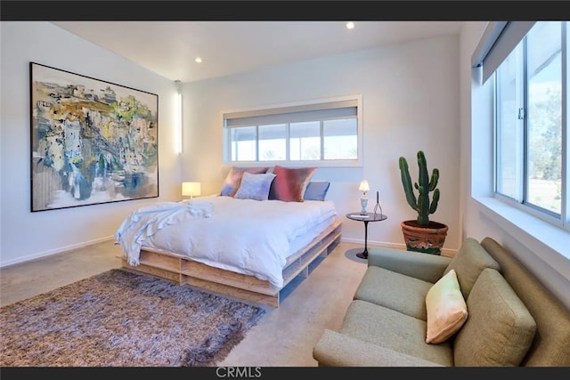 carpeted bedroom featuring multiple windows