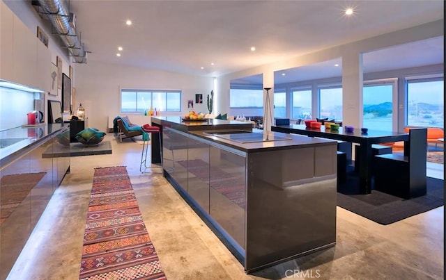 kitchen with a large island, white cabinetry, and a water view