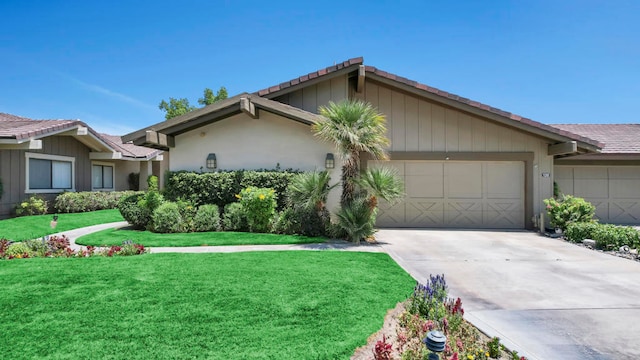 single story home featuring a front lawn and a garage