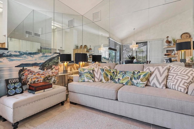 living room with a notable chandelier and light tile patterned floors