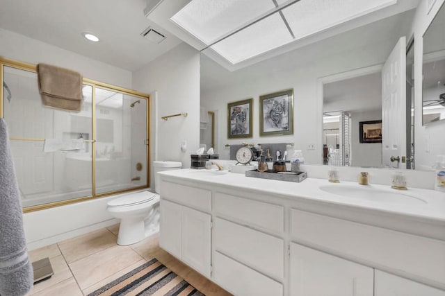 full bathroom with combined bath / shower with glass door, vanity, toilet, and tile patterned floors