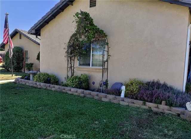 view of side of home featuring a yard