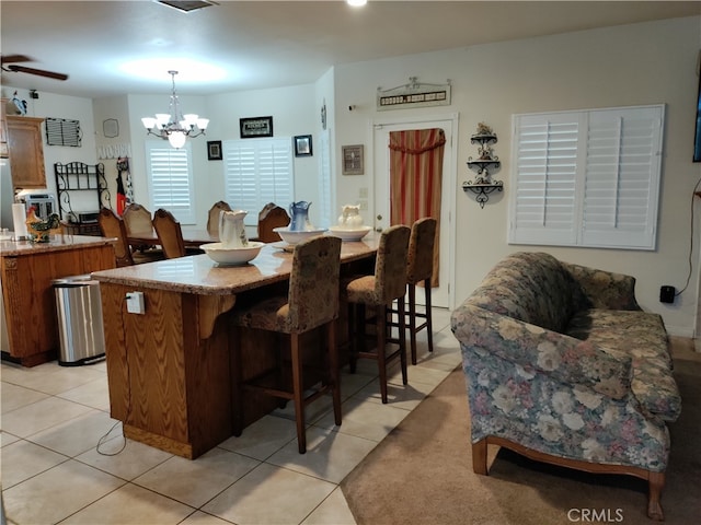 interior space featuring ceiling fan with notable chandelier