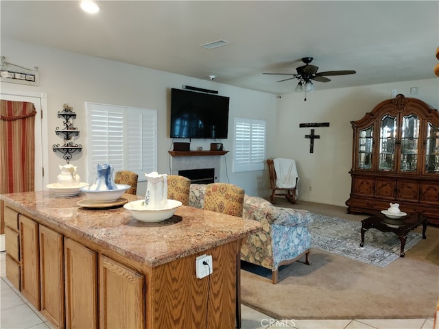 living room with ceiling fan and light tile patterned floors