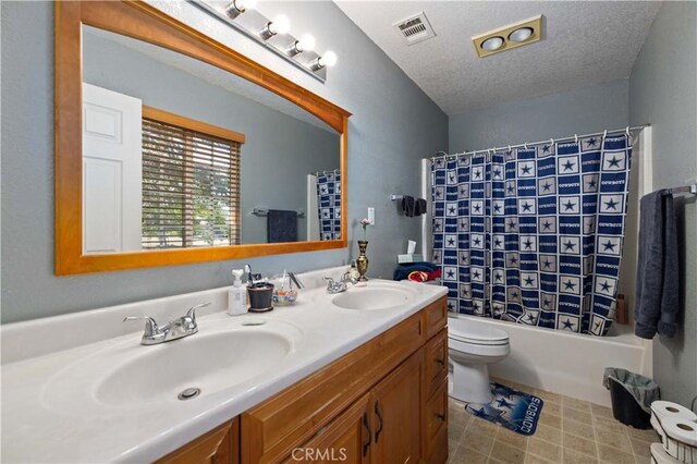 full bathroom featuring vanity, a textured ceiling, toilet, and shower / bath combo with shower curtain