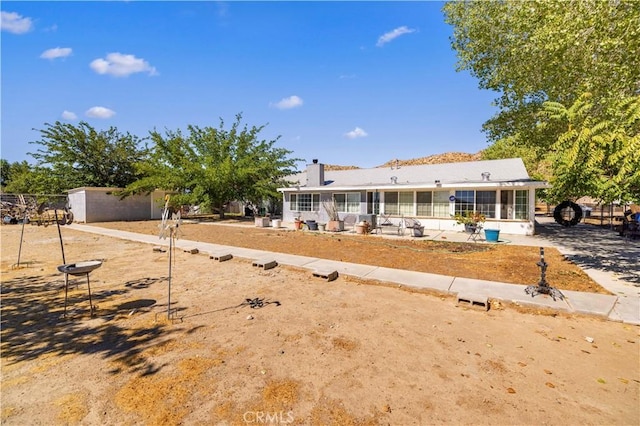 view of front of property with a patio area and a sunroom