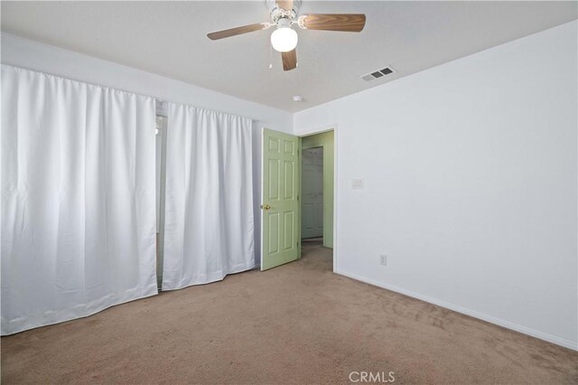 unfurnished room featuring carpet floors and ceiling fan