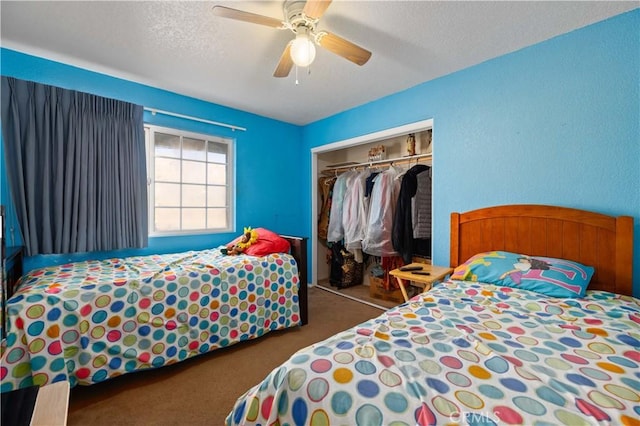 bedroom featuring ceiling fan, a closet, dark carpet, and a textured ceiling