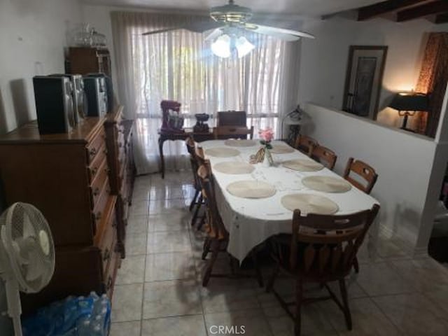 dining space featuring ceiling fan, beam ceiling, and light tile patterned flooring