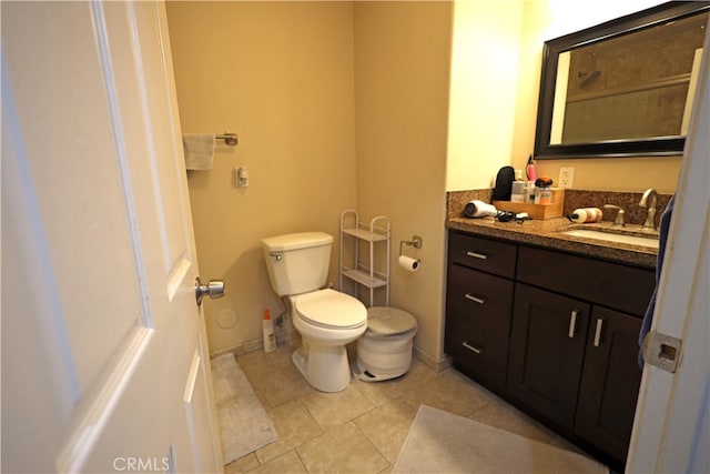 bathroom with vanity, toilet, and tile patterned flooring