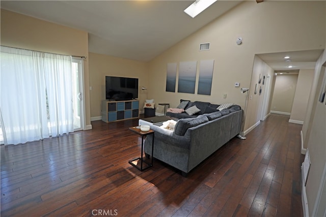 living room with high vaulted ceiling, dark hardwood / wood-style floors, and a skylight