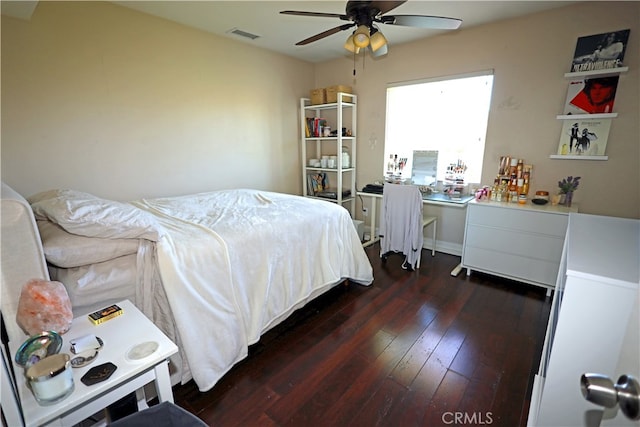 bedroom with ceiling fan and dark hardwood / wood-style flooring