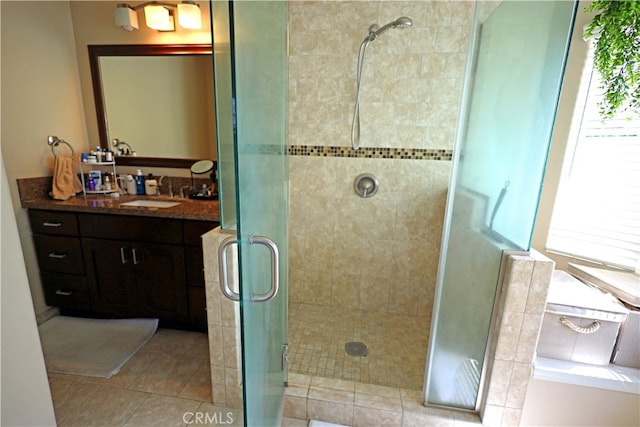 bathroom with walk in shower, tile patterned floors, and vanity