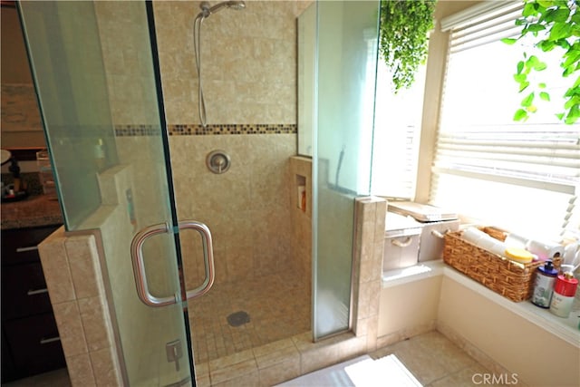 bathroom featuring plus walk in shower and tile patterned floors