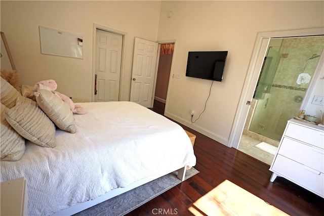 bedroom featuring dark hardwood / wood-style flooring and ensuite bathroom