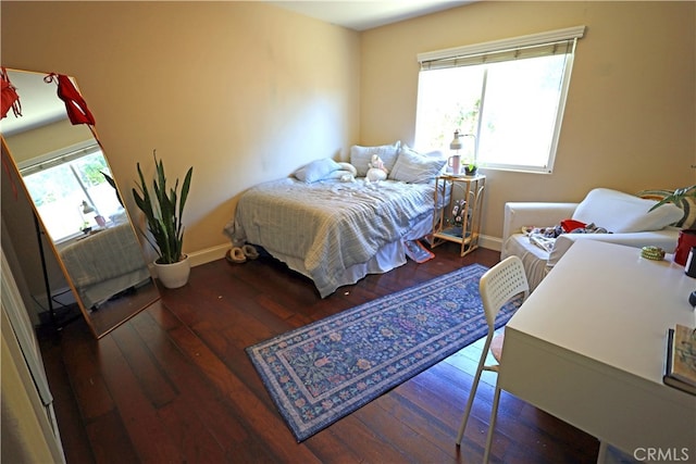 bedroom featuring multiple windows and hardwood / wood-style floors