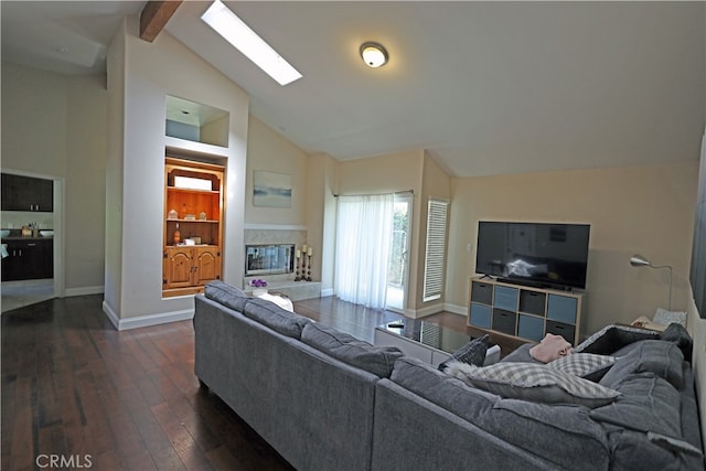 living room with a skylight, dark hardwood / wood-style floors, beamed ceiling, and high vaulted ceiling