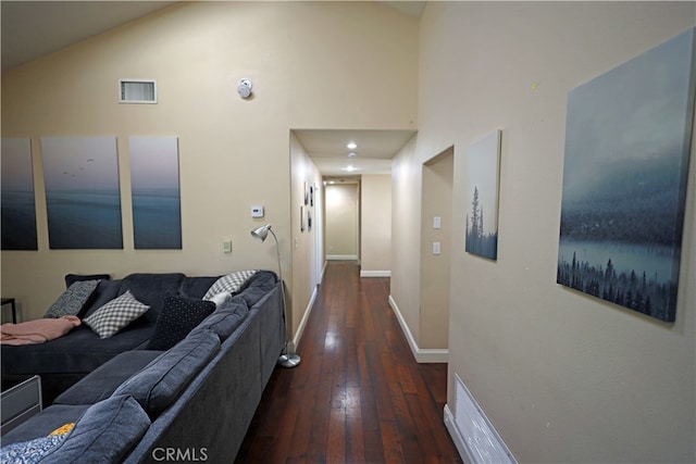 hall featuring dark hardwood / wood-style flooring and high vaulted ceiling