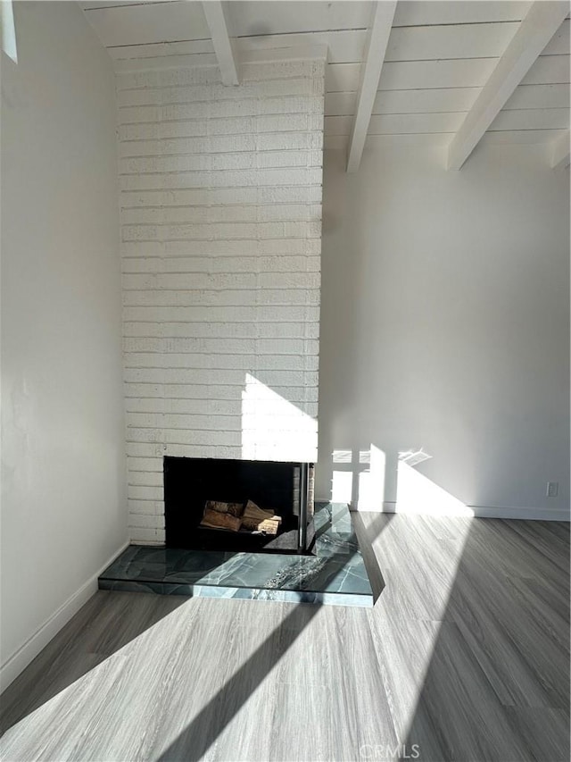 details featuring beamed ceiling, wood-type flooring, and a fireplace