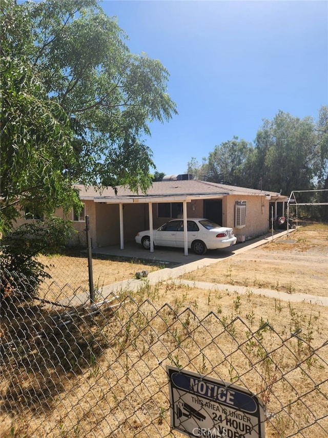 view of front of property featuring a carport