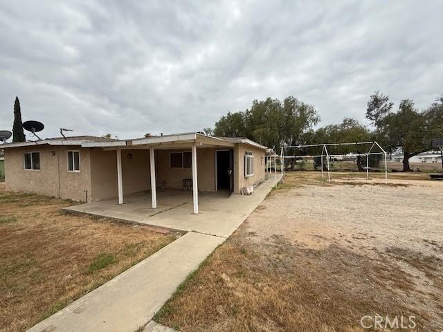 24062 Eucalyptus Ave, Moreno Valley, CA 92553 - rear view of house featuring a patio area and stucco siding
